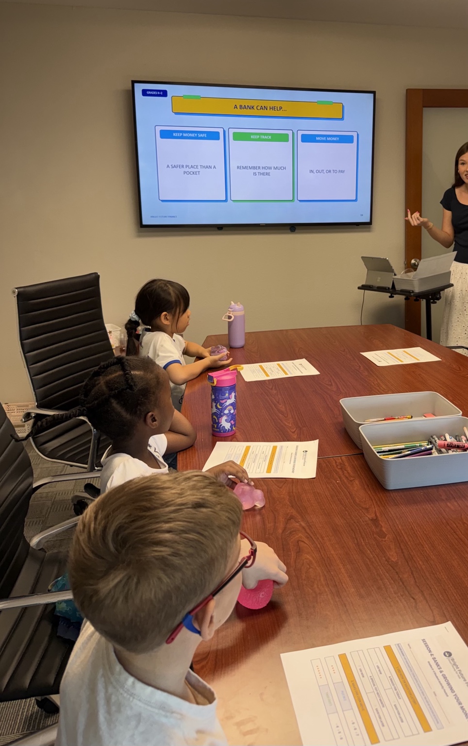 Students watching a lesson about how banks help people