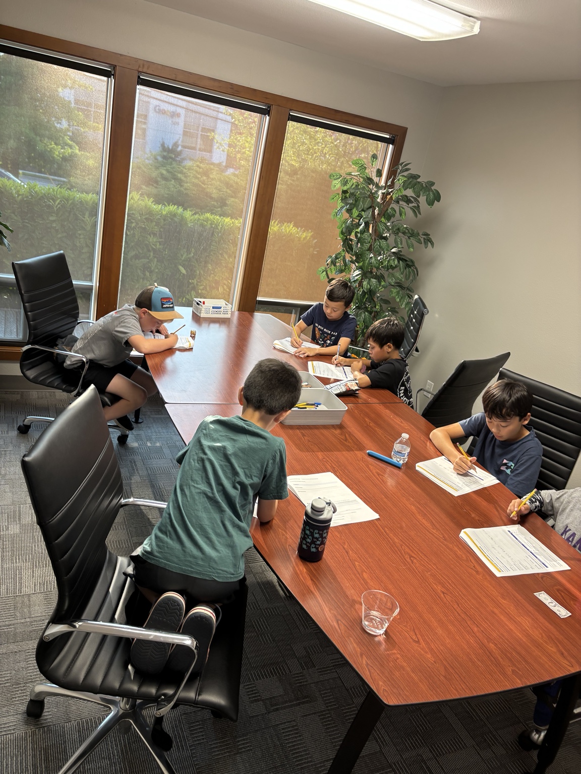 Students working on activities around a classroom table
