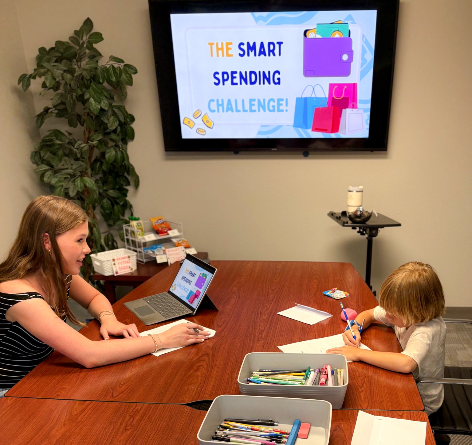 An instructor helping a student with a smart spending activity